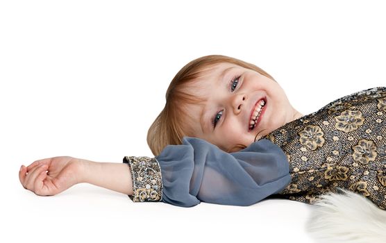 little girl lying on the floor in the studio on a white background