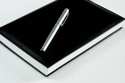 black note book and pen for records
