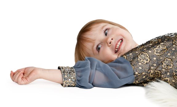 little girl lying on the floor in the studio on a white background