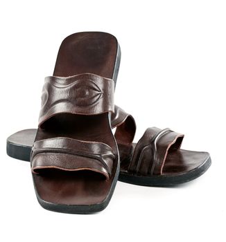 a pair of leather slippers for men isolated on white background