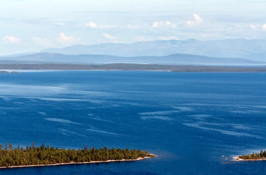 Landscape, the northern lake with islands in the backdrop of mountains Hibiny and clouds Hibyny
