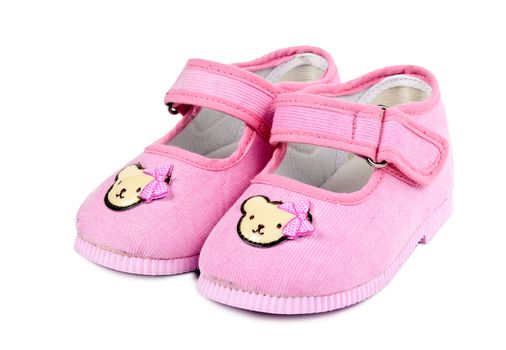 a pair of baby pink shoes isolated on white background