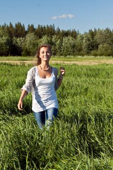 portrait of a beautiful young girl on green grass