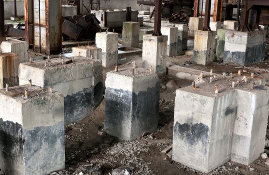 Dirty old abandoned concrete foundation in industrial building