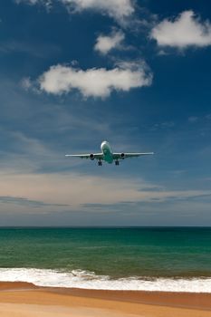 plane comes in to land on a tropical beach