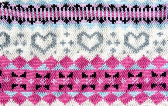 knitted colored background with a pattern in the shape of heart