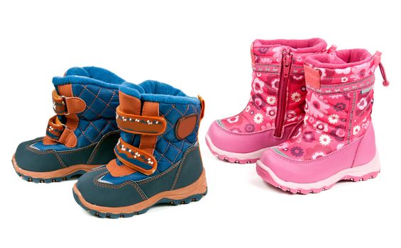 Two pairs of baby blue and pink boots isolated on white background