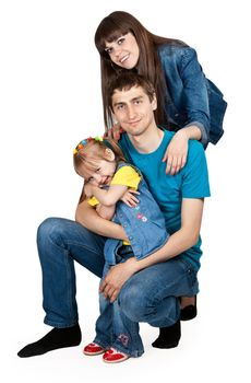 father, mother and young daughter in jeans at the studio on a white background