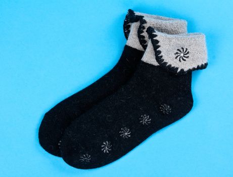 a pair of wool socks on a blue background