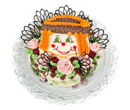 delicious cake with a pattern in the form of little faces clown on a transparent plate