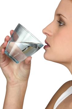 Young woman drinking a glass of water