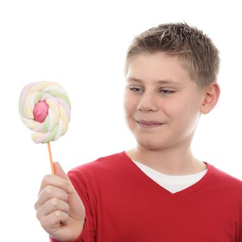 Portrait of joyful boy looking at lollipop