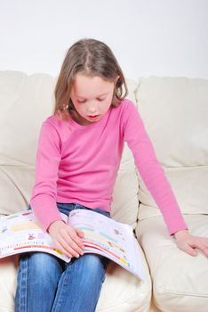 Girl student on the couch with a notebook