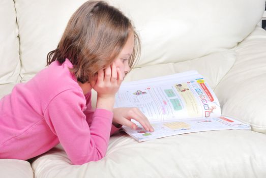 Girl student on the couch with a notebook