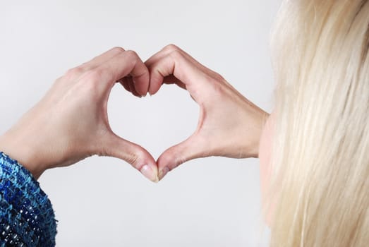 Woman making heart shape with her hands