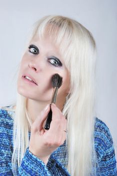  Woman applying makeup