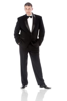 The elegant man in a classical tuxedo on a white background