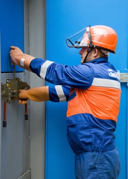 electrician working on a panel in the real world in the production of switches in a cell of the transformer substation