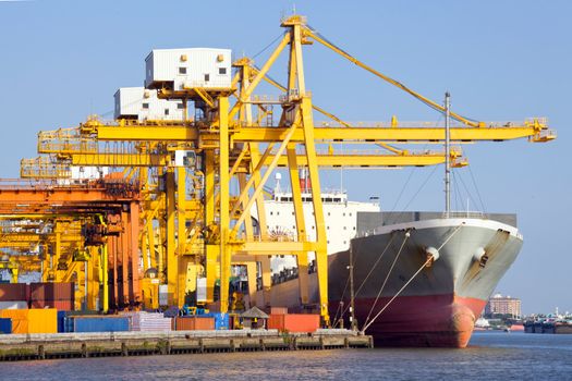 Cargo industrial ship unloading goods at Terminal Port