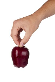 Red delicious apple in a hand isolated on a white background.