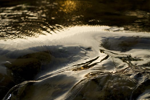 Close view of fast flowing fresh water on a river.