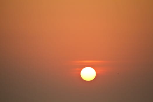 View of a big red sun at sunset in the sky.