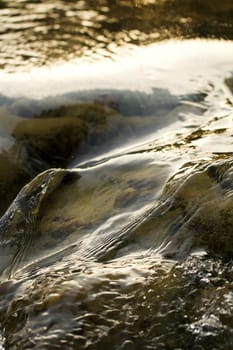 Close view of fast flowing fresh water on a river.