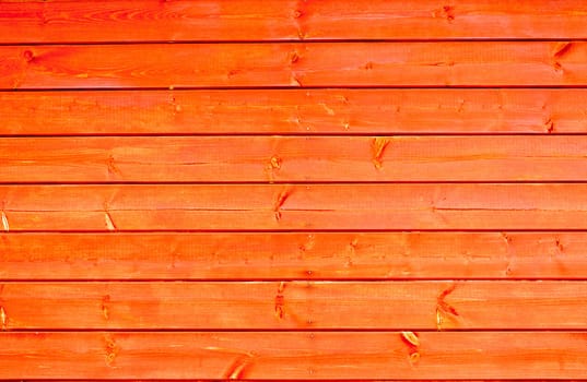 Close up of new orange colored wooden boards background