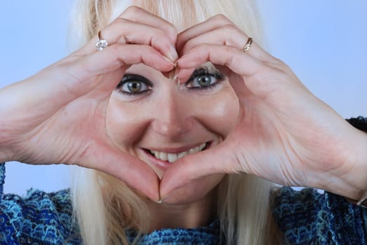 Woman making heart shape with her hands