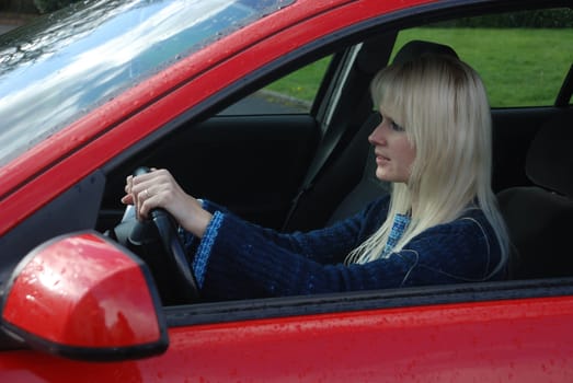 woman driving a red car