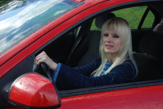 woman driving a red car