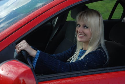 woman driving a red car