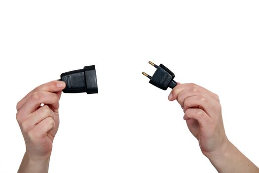 hands holding two prong plug