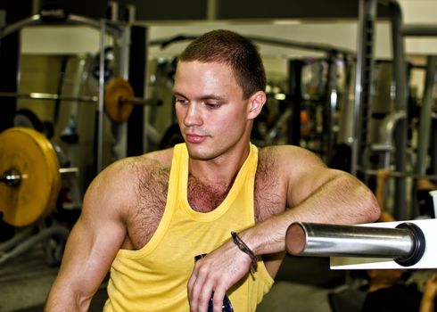 Portrait of handsome bodybuilder in fitness club