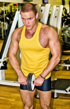 Portrait of handsome bodybuilder in fitness club