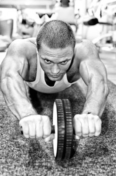 Man doing athlete exercise in fitness club