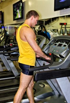 Man doing athlete exercise in fitness club