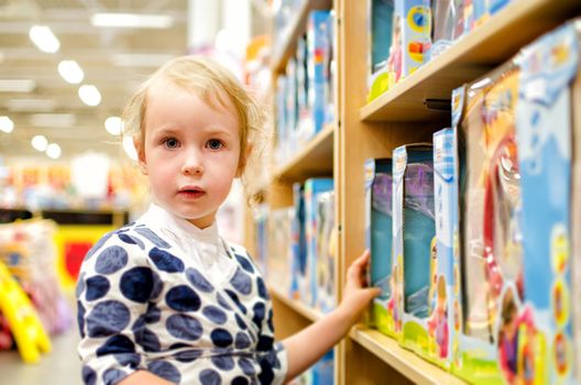 Little girl is shopping at the children's store.