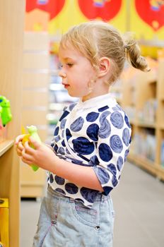 Little girl is shopping at the children's store.