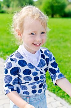 Smiling little girl in the park.