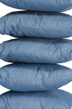 stack of blue denim pillows isolated on white