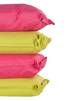 bright stack of pink and green pillows isolated on white