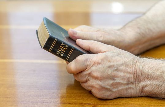 holding the bible over table