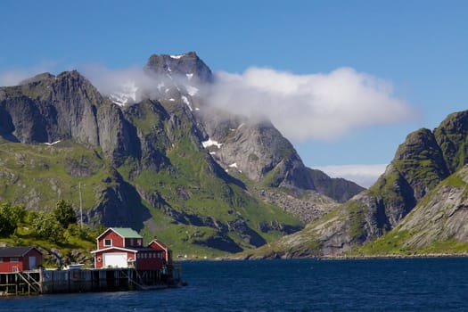 Picturesque mountain peaks towering above fjord on Lofoten islands in Norway