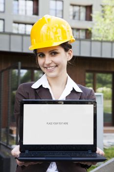 Female construction engineer show something on laptop