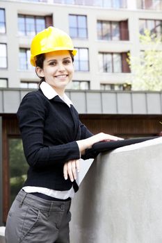 Female construction engineer and yellow helmet