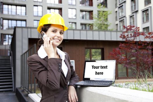 Female construction engineer show something on laptop