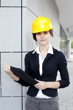 Female construction engineer and yellow helmet