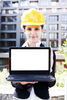 Female construction engineer show something on laptop