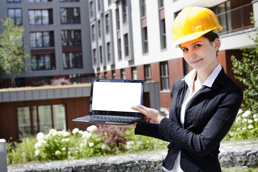 Female construction engineer show something on laptop